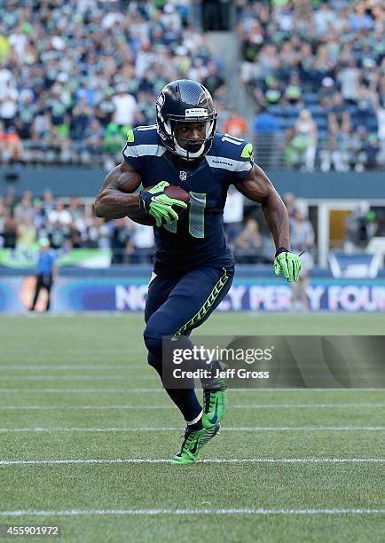 Wide receiver Percy Harvin of the Seattle Seahawks carries the ball against the Denver Broncos at CenturyLink Field on September 21, 2014 in Seattle,...