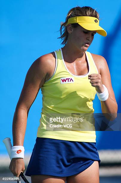 Maria Teresa Torro Flor of Spain competes with Garbine Muguruza Blanco of Spain during day two of the 2014 Dongfeng Motor Wuhan Open at Optics Valley...