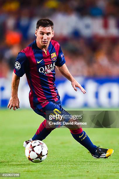 Lionel Messi of FC Barcelona runs with the ball during the UEFA Champions League Group F match between FC Barcelona and APOEL FC at the Camp Nou...