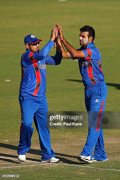 Samiullah Shinwari and Dawlat Khan of Afghanistan celebrate the wicket of Marcus Harris of the WA XI during the One Day tour match between the...