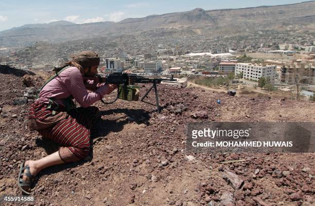Yemeni Shiite Huthi anti-government rebel holds a position at an army base which they captured without resistance just hours before the signing a...