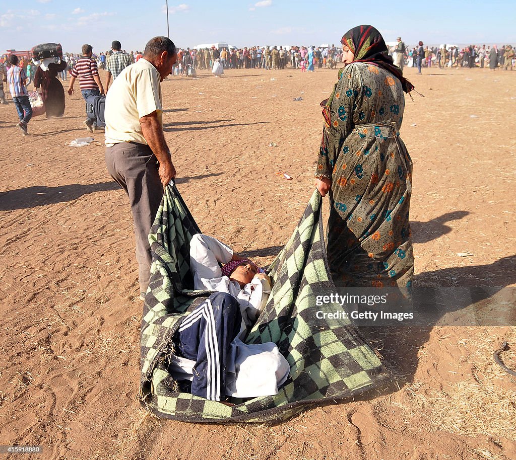 Syrian Kurds Fleeing The Islamic State Militants Cross Into Turkey