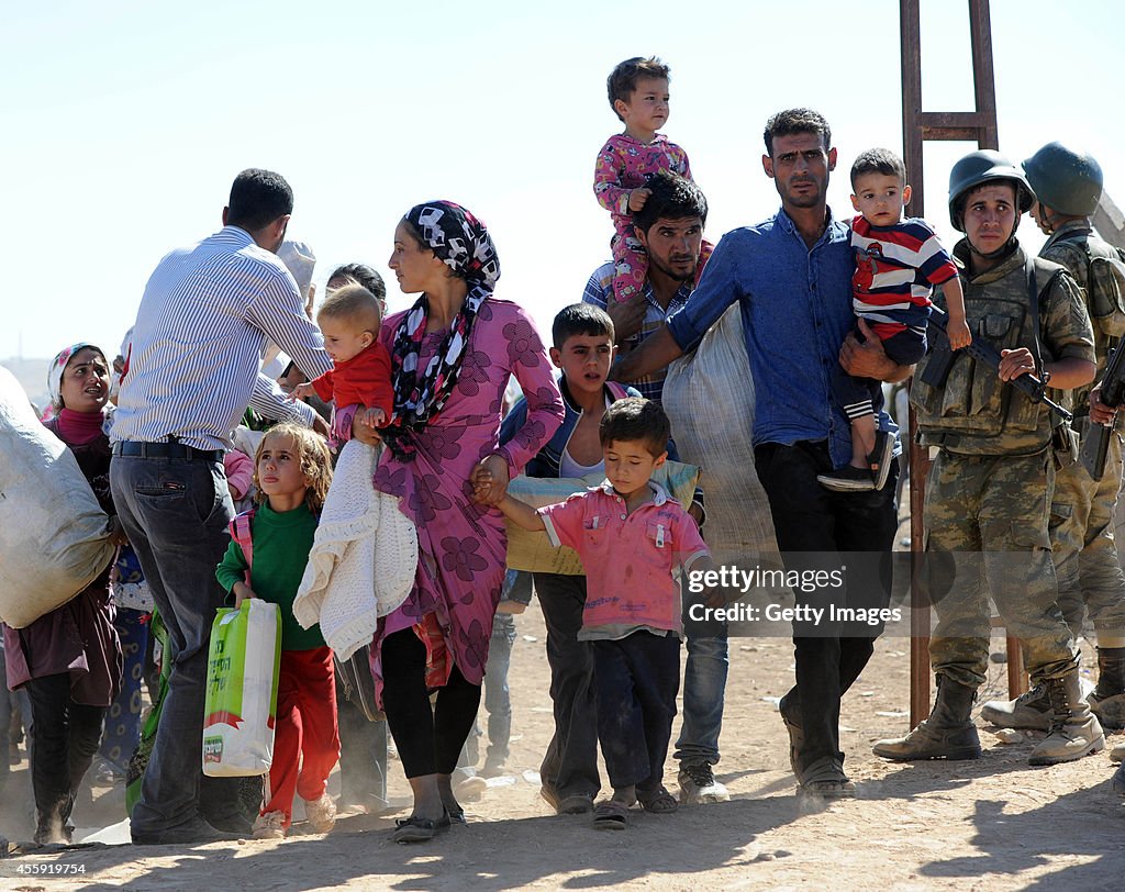 Syrian Kurds Fleeing The Islamic State Militants Cross Into Turkey