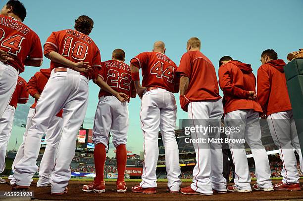 Players of the Los Angeles Angels of Anaheim stand for the national anthem before the game against the Seattle Mariners on September 17, 2014 at...