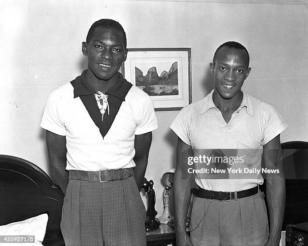 Dave Albritton, who broke High Jump record and Jesse Owens, who won 100 meter, 200 meter and Broadjump events pose at Hotel Lincoln before departing...