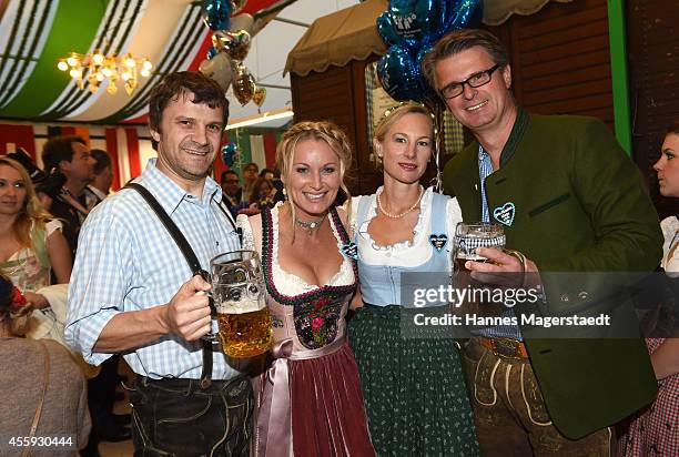 Richard George and Eva Gruenbauer, Constanze and Juergen Hausmann attend the BMW Armbrustschiessen at Armbrust-Schuetzenfesthalle during Oktoberfest...