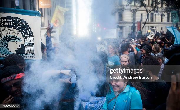 Protesters calling for massive economic and political changes to curb the effects of global warming dance and throw blue powder after being turned...