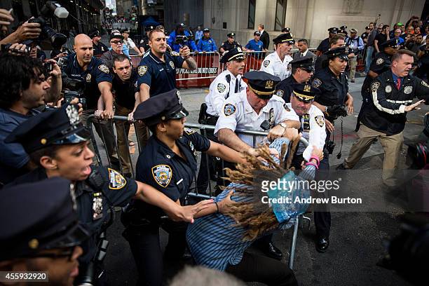 Protesters calling for massive economic and political changes to curb the effects of global warming clash with police as try to walk down Wall Street...