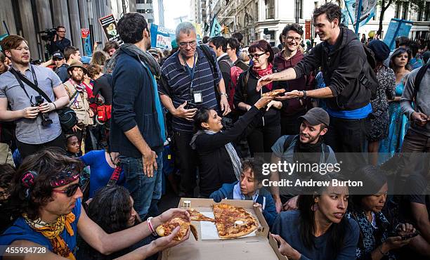 Protesters demanding economic and political changes to curb the effects of global warming hold a sit-in at Wall Street and Broadway after clashing...