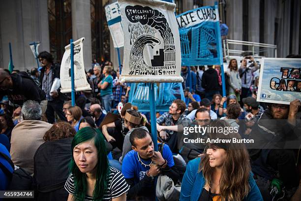 Protesters demanding economic and political changes to curb the effects of global warming hold a sit-in at Wall Street and Broadway after clashing...