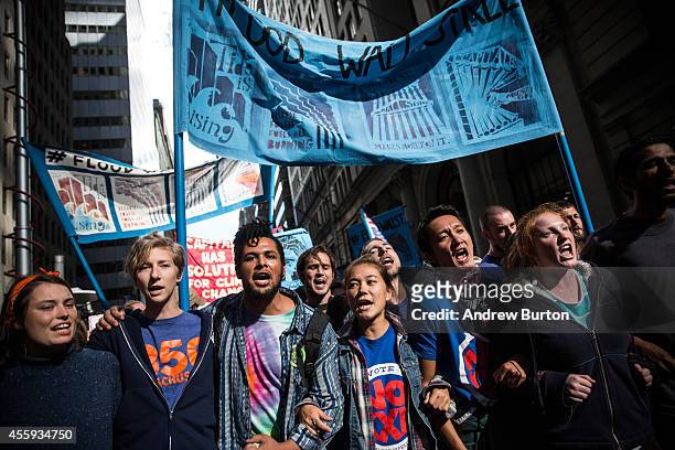 Protesters demanding economic and political changes to curb the effects of global warming march toward the New York Stock Exchange on September 22,...