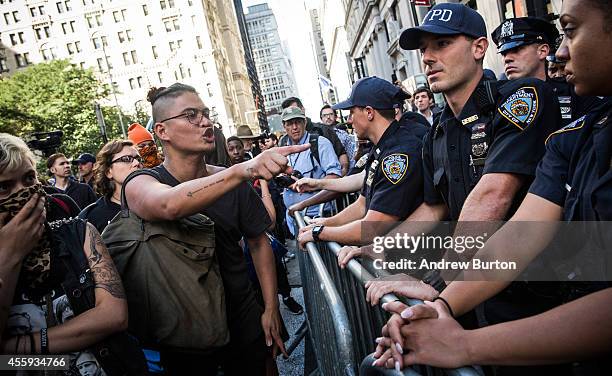 Protesters demanding economic and political changes to curb the effects of global warming clash with police as try to walk down Wall Street towards...