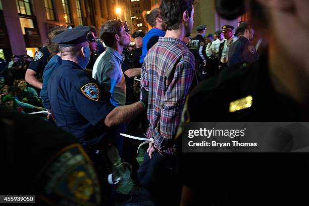 Police officers arrest demonstrators on Broadway following the Flood Wall Street protest after asking them to disperse on September 22, 2014 in New...