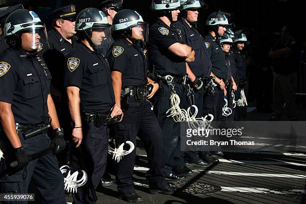 Police line the middle of Broadway during the Flood Wall Street protest on September 22, 2014 in New York City. The Flood Wall Street protest came on...
