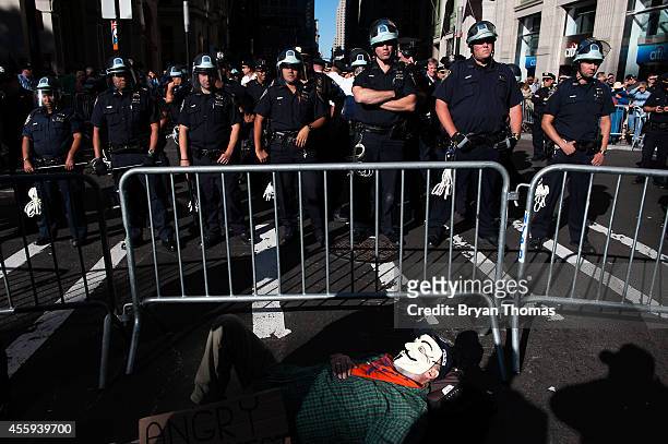 Richard Lynch of Staten Island lies in front of a police barricade during the Flood Wall Street protest on September 22, 2014 in New York City. The...