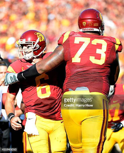 Cody Kessler celebrates with offensive tackle Zach Banner after a touchodown to take a 21-0 lead over the Fresno State Bulldogs during the first...