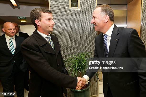 Newly elected Prime Minister John Key greets new ACT MP David Seymour while ACT Leader Dr Jamie Whyte looks on at The Beehive on September 23, 2014...