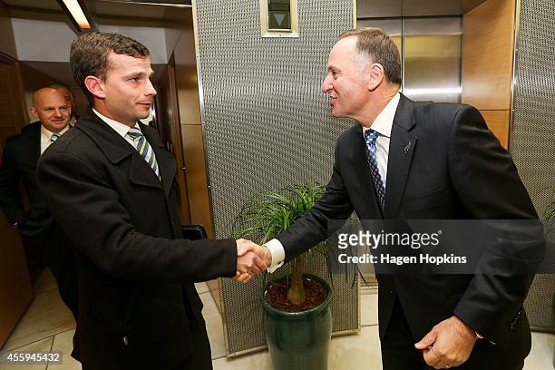 Newly elected Prime Minister John Key greets new ACT MP David Seymour while ACT Leader Dr Jamie Whyte looks on at The Beehive on September 23, 2014...