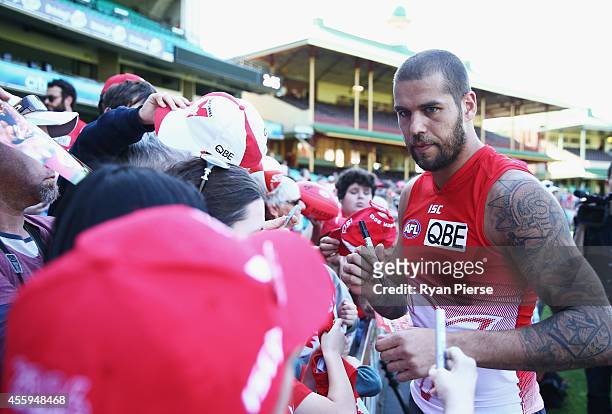 Lance Franklin of the Swans signs autographs for fans during a Sydney Swans AFL training session at Sydney Cricket Ground on September 23, 2014 in...