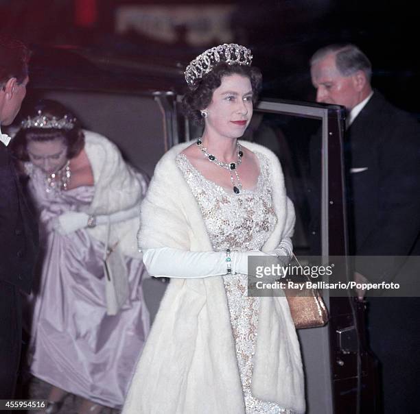 Queen Elizabeth II, accompanied by her sister Princess Margaret , attends the premiere of "West Side Story" at the Odeon Cinema in Leicester Square,...