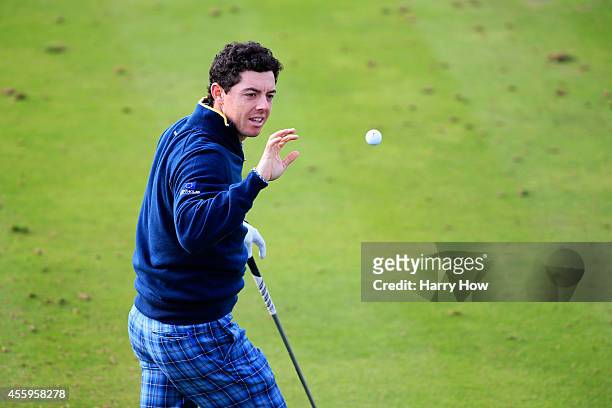 Rory McIlroy of Europe catches a golf ball during practice ahead of the 2014 Ryder Cup on the PGA Centenary course at the Gleneagles Hotel on...