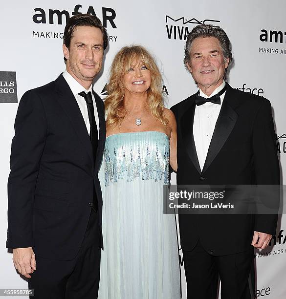 Actor Oliver Hudson, actress Goldie Hawn and actor Kurt Russell attend the amfAR Inspiration Gala at Milk Studios on December 12, 2013 in Hollywood,...