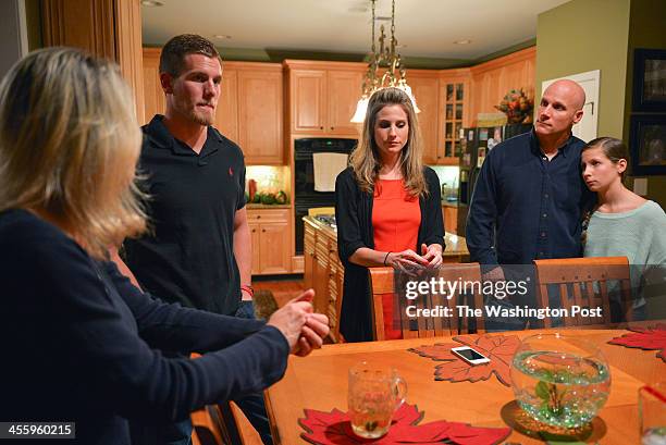 Spenser Rositano, second from left, stands by the kitchen table with his mom, Marcy, left; sister, Aubrey, third; dad, Wayne, fourth; and younger...