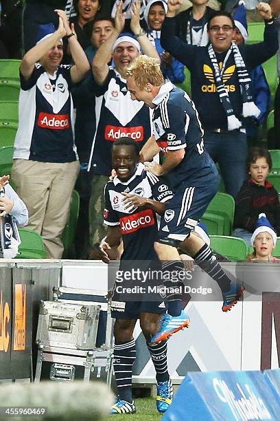 Adama Traore of the Victory is jumped on by Mitchell Nichols after scoring a goal during the round 10 A-League match between the Melbourne Victory...