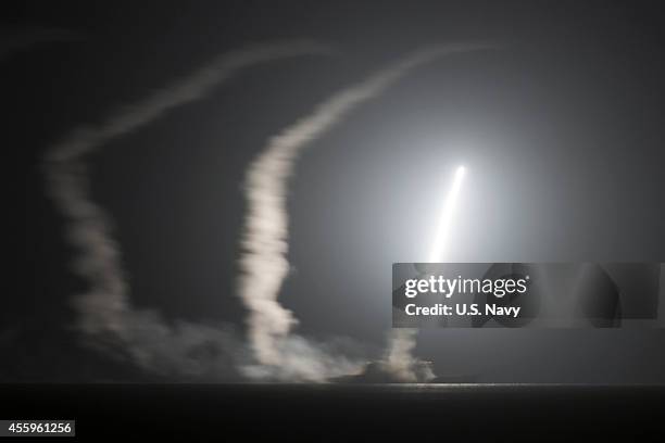 In this handout image provided by the U.S. Navy, The guided-missile cruiser USS Philippine Sea launches a Tomahawk cruise missile on September 23,...