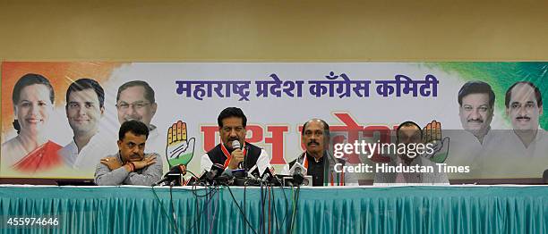 Maharashtra CM Prithviraj Chavan with state Congress chief Manikrao Thakre and party leader Sanjay Nirupam addressing the media on September 23, 2014...