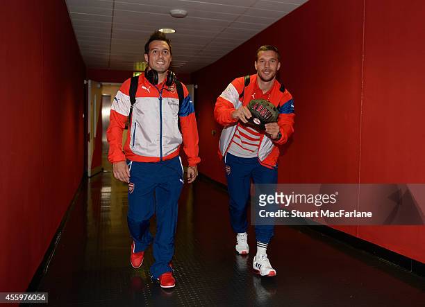 Arsenal's Santi Cazorla and Lukas Podolski arrive at the players entrance before the Capital One Cup Third Round match between Arsenal and...