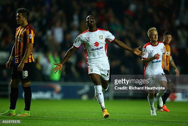Benik Afobe of MK Dons scores the first goal during the Capital One Cup Third Round match between MK Dons and Bradford City at Stadium mk on...