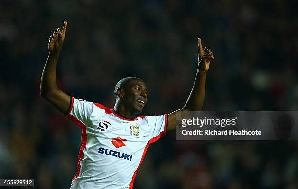 Benik Afobe of MK Dons celebrates scoring the first goal during the Capital One Cup Third Round match between MK Dons and Bradford City at Stadium mk...