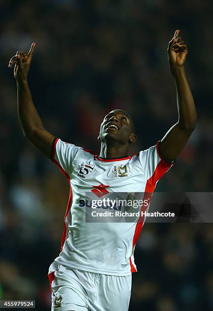 Benik Afobe of MK Dons celebrates scoring the first goal during the Capital One Cup Third Round match between MK Dons and Bradford City at Stadium mk...