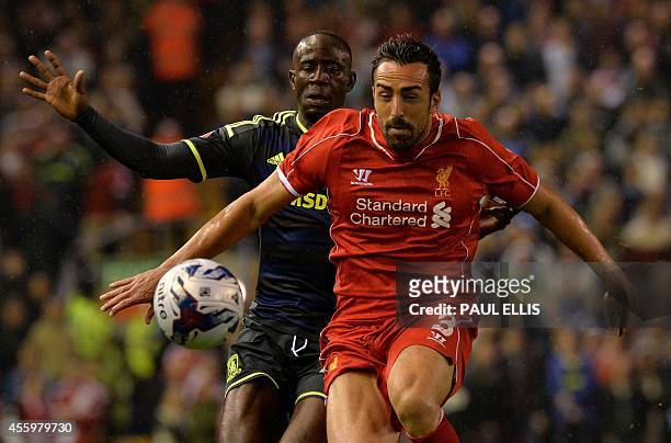 Liverpool's Spanish defender Jose Enrique vies with Middlesbrough's Ghanaian midfielder Albert Adomah during the English League Cup third round...