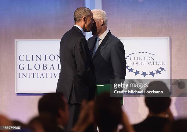 President of the United States Barack Obama shakes hands with Former U.S. President Bill Clinton before closing the "Cities as Labs of Innovation"...