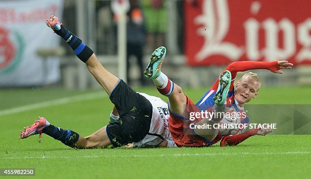 Paderborn's Algerian midfielder Idir Ouali and Bayern Muncih's midfielder Sebastian Rode vie for the ball during the German first division Bundesliga...