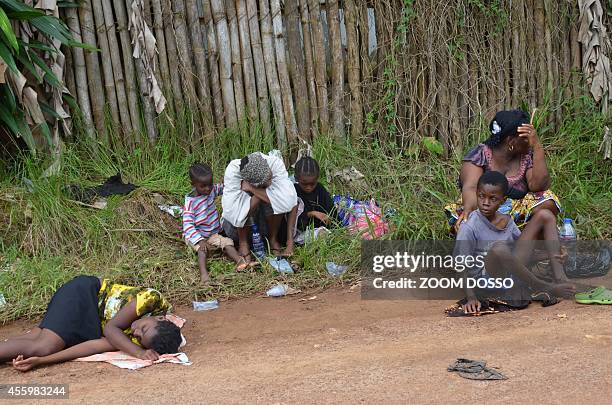 Resident sick from the ebola virus waits on September 23, 2014 outside "Island Clinic", a new Ebola treatment centre that opened in Monrovia. The...