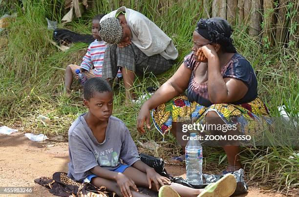 Resident sick from the ebola virus waits on September 23, 2014 outside "Island Clinic", a new Ebola treatment centre that opened in Monrovia. The...