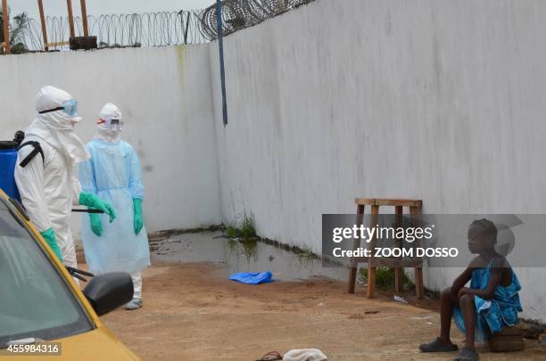 Girl cries outside the "Island Clinic", a new Ebola treatment centre that opened in Monrovia after the death of her father and her mother by ebola on...