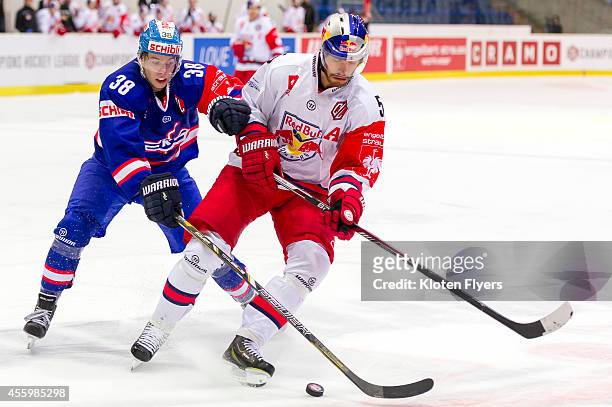 Lukas Frick from Kloten Flyers and Thomas Raffl from RB Salzburg battle for the puck during the Champions Hockey League group stage game between...