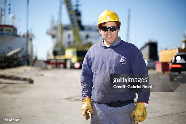 Operator of the Port Constructions and Waterways National Department poses for a photo during a working day at Demarchi Island on September 17, 2014...