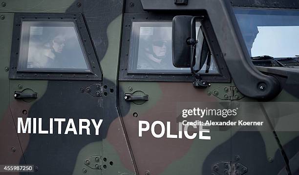 Soldiers of the Military Police of the Bundeswehr, the German armed forces, sit inside an armoured vehicle `Eagle IV"and wait to investigate on a...