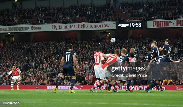 Alexis Sanchez scores Arsenal's goal from a free kick during the Capital One Cup 3rd match between Arsenal and Southampton at Emirates Stadium on...