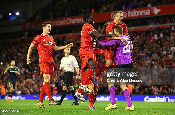 Lucas, Kolo Toure and Simon Mignolet of Liverpool celebrate after winning the match on penalties after a miss from Albert Adomah of Middlesbrough...