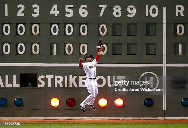 Yoenis Cespedes of the Boston Red Sox fails to make a catch in left field allowing two runs to score in the 8th inning against the Tampa Bay Rays...