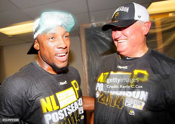 Manager Clint Hurdle and Starling Marte of the Pittsburgh Pirates celebrate clinching a National League playoff spot after their 3-2 win over the...