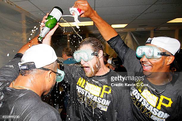 Francisco Liriano, John Axford, and Stolmy Pimentel of the Pittsburgh Pirates celebrate clinching a National League playoff spot after their 3-2 win...