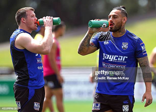 Josh Morris and Reni Maitua take a drink break during a Canterbury Bulldogs NRL training session at Belmore Sports Ground on September 24, 2014 in...