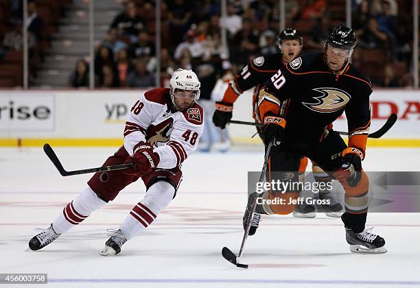 David Steckel of the Anaheim Ducks is pursued by Jordan Martinook of the Arizona Coyotes for the puck in the third period at Honda Center on...
